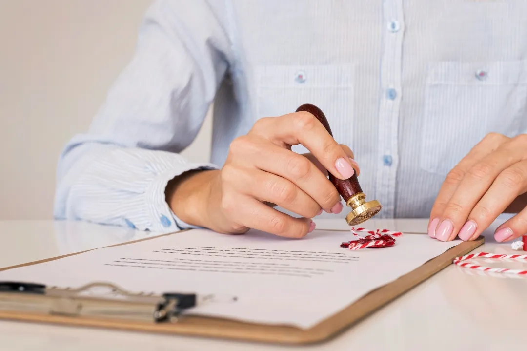 A person reviewing documents, ensuring compliance with rental business regulations.