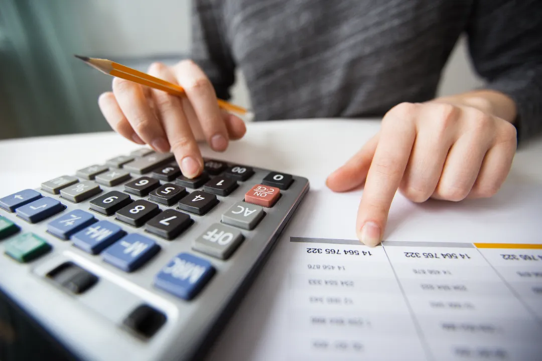 Business owner calculating mailbox rental pricing strategy.