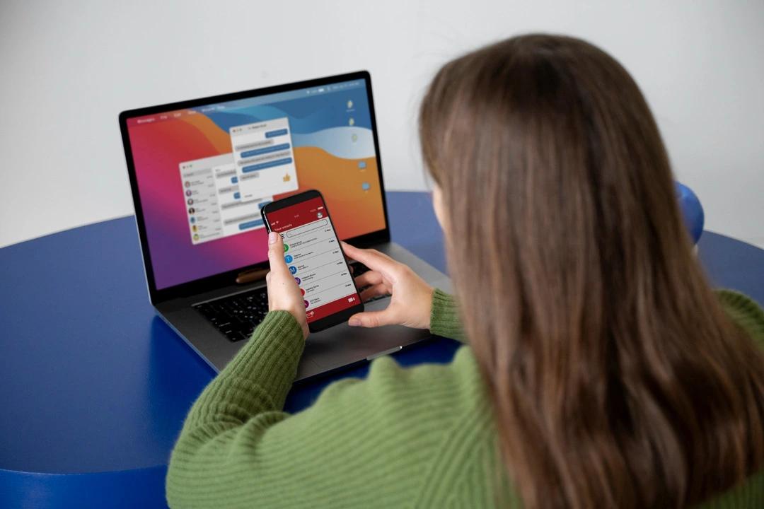 User navigating a mobile-friendly website on both smartphone and laptop.