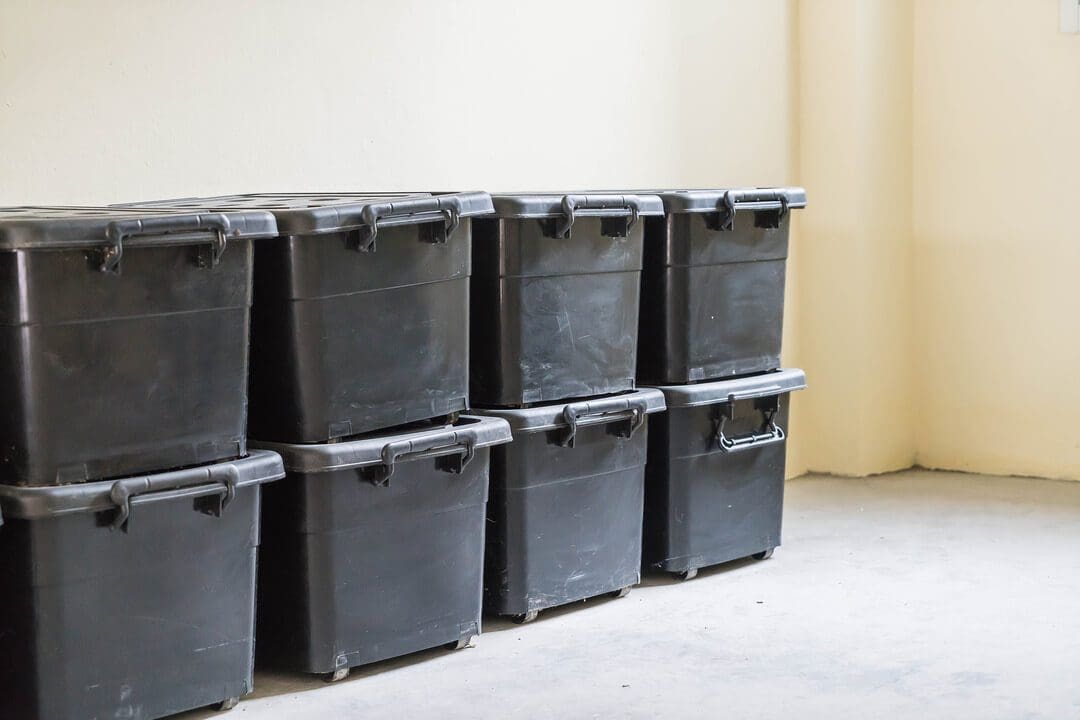 Durable black storage containers for moving supply rental business.
