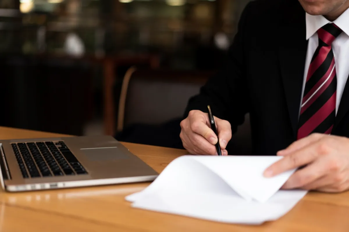 Business owner signing paddleboard rental documents